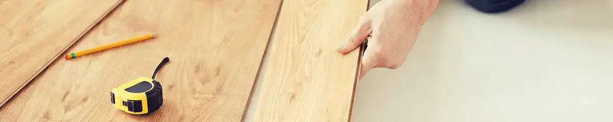 A professional installing wood flooring in Gilbert, AZ