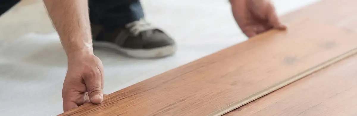 A professional installing laminate flooring in Gilbert, AZ